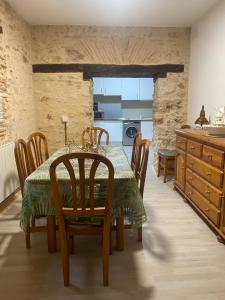 a kitchen and dining room with a table and chairs at La Casona de 1717 in El Burgo de Osma