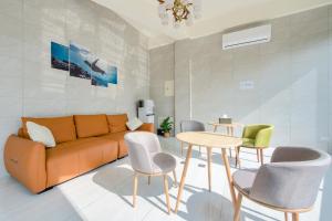 uma sala de estar com um sofá, cadeiras e uma mesa em Best Home 929 em Xiaoliuqiu