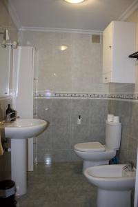a bathroom with a toilet and a sink at Apartamento Cueto in Soto del Barco