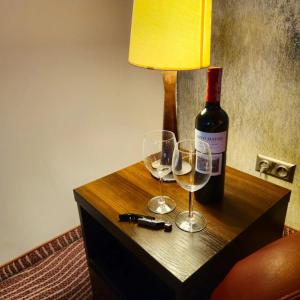 涅波沃米采的住宿－Hotel Azalia & Spa，桌子上放有一瓶葡萄酒和两杯酒