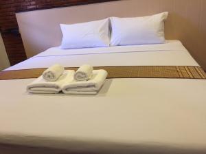 Postel nebo postele na pokoji v ubytování Ben Guesthouse