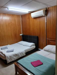 a bedroom with two beds on a boat at Meera Heritage Motel in George Town