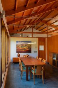 a dining room with a wooden table and chairs at La Panera de Pucho in Pontevedra +37 photos
