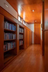 a hallway with wooden bookshelves and shelves filled with books at La Panera de Pucho in Pontevedra
