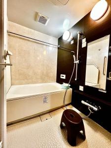 a bathroom with a bath tub and a toilet in it at 水之道 in Osaka