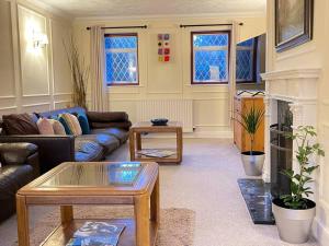 a living room with a couch and a table at Check our discount Executive 3 bed house in St. Ives