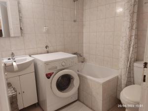 a bathroom with a washing machine and a toilet at AQA - No4, 360 degrees photos of the apartment to know exactly what you are booking in Athens