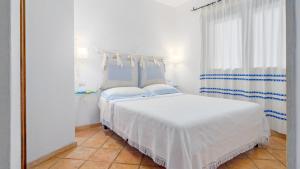 a bedroom with a white bed and a large mirror at CASA MAESTRALE 6, Emma Villas in Palau