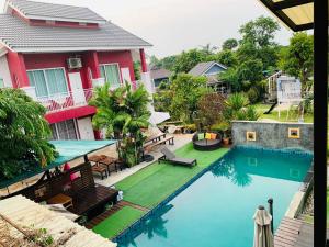 an image of a swimming pool in front of a house at Na Na Doo Homestay in Chiang Rai