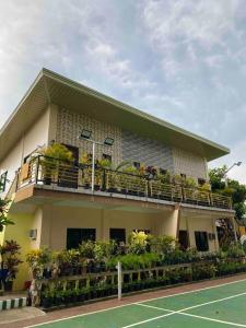 a building with a tennis court in front of it at Spacious Studio Apartment 3 with Pool in Alburquerque