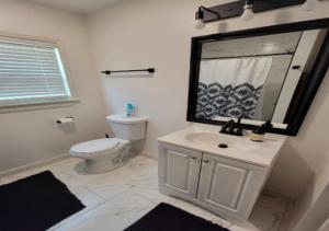 a bathroom with a toilet and a sink and a mirror at Cozy One Bedroom Apartment At UWS in New York