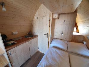 Kleines Zimmer mit einem Bett und einem Waschbecken in der Unterkunft Ferienpark Auf dem Simpel - Schnuckenbude 3 in Soltau