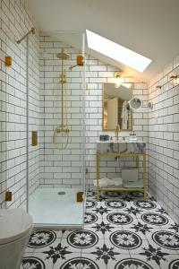 a bathroom with a shower and a sink and a mirror at Dona Maria Hotel in Figueira da Foz