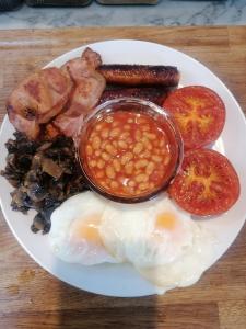 a plate of breakfast food with eggs beans and bacon at No. 30 in Aberdare