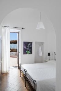 a bedroom with a bed and a view of the ocean at Albergo Il Monastero in Ischia