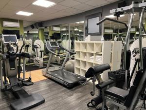 a gym with several treadmills and machines in it at Amatì Design Hotel in Zola Predosa