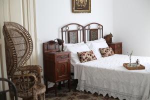 a bedroom with a bed and a chair at Casa Aulivo in Caiazzo