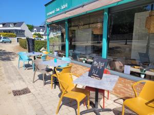 a row of tables and chairs outside of a restaurant at Le petit Montmartre in Dinard