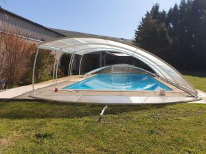 a hot tub under a cover in a yard at Loc'citanie chambres double in Aussillon