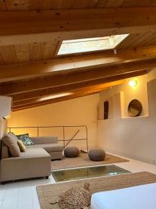a living room with a ceiling with a skylight at Massaria Bove in Cervino