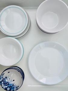 a group of white plates sitting on a table at Easy Homestay in Mukah