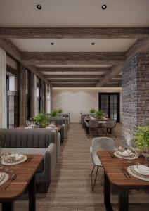 a dining room with tables and chairs and a brick wall at Burchmulla Resorts in Burchmulla
