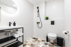 a white bathroom with a sink and a toilet at Rare Apartments - Self Check-In Microapartments in Tartu