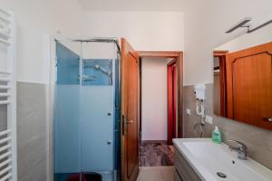 a bathroom with a glass shower and a sink at Zagar House-Venice Airport Close-by Apt W Parking in Campalto +12 photos