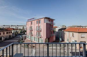 a pink building on a city street with buildings at Zagar House-Venice Airport Close-by Apt W Parking in Campalto
