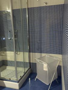a bathroom with a shower and a glass shower stall at Le radici dell’Etna holiday house in Paterno