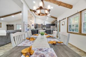a dining room and kitchen with a long table and chairs at Whiskey Pines Retreat! Single Level Home, Outdoor Firepit, AC, BBQ! Sleeps 9 in Lake Harmony! in Lake Harmony