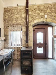 a room with a wood stove and a door at Cueva Atlantis in Stamnoí