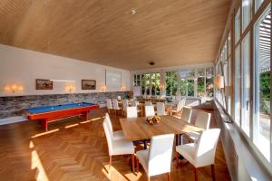 a dining room with a pool table and chairs at Boutique Hotel Bellevue in Interlaken