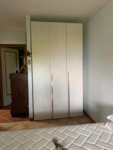 een grote witte kast in een kamer met een bed bij Appartamento Lory in Baveno