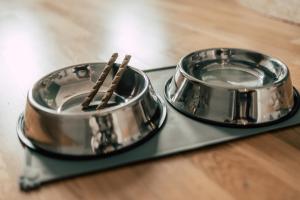two metal ashtrays sitting on top of a wooden table at Luga Homes - Karli in Leipzig