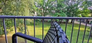 a bench on a balcony looking out at a park at Apartman Wolf in Varaždin