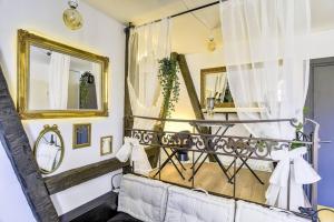 ein Wohnzimmer mit einem Sofa und einem Spiegel in der Unterkunft Seyboth - Charmant studio au cœur de la Petite France in Straßburg