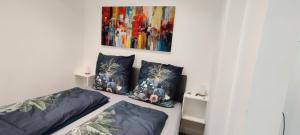 a room with two beds and a painting on the wall at Am Boulevard in Gengenbach