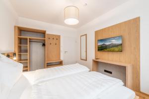 Mountain Lodge Gröbming tesisinde bir odada yatak veya yataklar