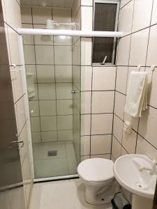 a bathroom with a shower and a toilet and a sink at Gravatá Praia Hotel- Frente ao mar in Navegantes