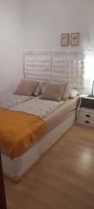 a white bed with pillows on it in a room at Aperi View in Karpathos