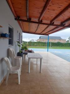 un patio con mesa, sillas y piscina en Alojamiento Los Imigrantes en Chajarí