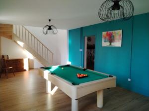 a billiard table in a room with a staircase at Au gîte Sérénité in Mouthier-en-Bresse