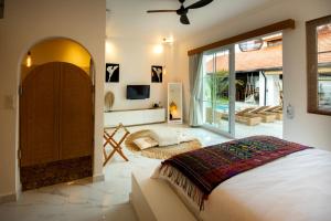 a bedroom with a bed and a tv in it at Keramas Moonlight Villa in Keramas