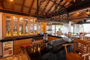 a bar in a restaurant with a counter and chairs at Keramas Moonlight Villa in Keramas