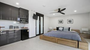 a bedroom with a bed and a ceiling fan at Riptides Booker Bay -Pay 2, Stay 3 nights this WINTER in Booker Bay