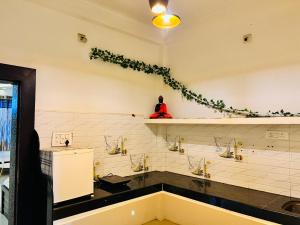 a bathroom with three sinks and a plant on the wall at A.P. Suite - Luxury Villa in Ujjain