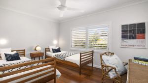 a bedroom with two beds and a window at The Patonga Pearl in Patonga