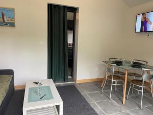 a living room with a couch and a table at TAMA in Saint-Lunaire