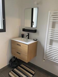 a bathroom with a sink and a mirror at TAMA in Saint-Lunaire +13 photos